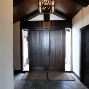 Wood door front entry design in Big White Ski chalet created by Kelowna & Big White Custom home design builder designer