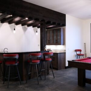 Bar with granite countertops & wood in ski chalet created by Big White builder near me & Kelowna home designer & high-end builder