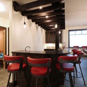 Bar with wood rafters created by Big White Custom home design builder near me & Kelowna contractor & home designer near me
