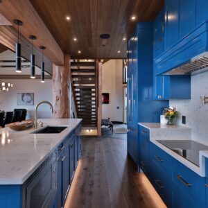 Blue kitchen with granite countertops designed by Kelowna home builder & Big White custom home builder designer