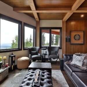 Rock fireplace & custom dart board in ski chalet designed by Kelowna home builder & Big White custom home builder designer