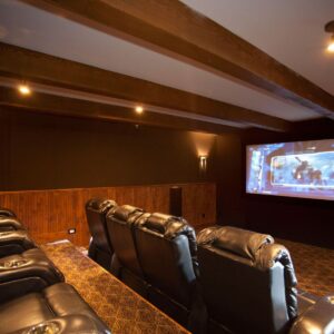 Timber beam feature in home theatre in ski chalet designed by Big White Custom Chalet Designer & Kelowna Custom home builder near me