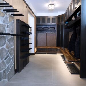 Rock wall accent in custom boot room design in ski chalet at Big White Ski Resort built by Big White custom chalet builder & Kelowna contractor & Kelowna home designer