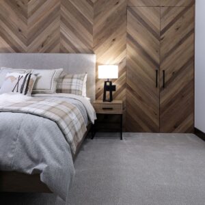Luxury bedroom with wood paneling in chevron design built by Big White & Kelowna custom home builder designer