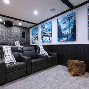 Custom theatre room with unique sound dampening panel artwork designed by Big White & Kelowna custom home builder designer