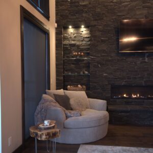 Custom rock wall in living room designed & built by Big white ski chalet builder near me & Kelowna custom home builder Weninger Construction & Design
