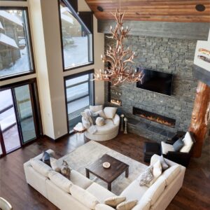 Bright living room with vaulted ceilings created by Kelowna construction company & Big White Custom home builder designer