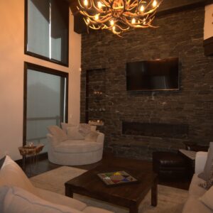 Rock fireplace in custom living room design built by Big White custom home builder & Kelowna building contractor