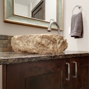 Stone sink on granite countertops created by Kelowna contractor & Big White Custom home builder designer