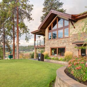 Large picture windows framed by rockwork designed by Kelowna commercial contractor & Kelowna construction company
