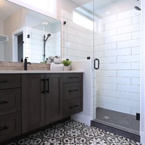 Subway tile shower design in ensuite bathroom created by Big White custom chalet builder & Kelowna construction company & home designer