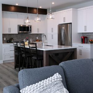 Open kitchen design with eating bar created by Big White custom builder & Kelowna home builder & home designer
