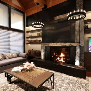 Stone slab mantle on wood fireplace with metal accents designed & built by Big White luxury builder near me & Kelowna custom home builder Weninger Construction & Design