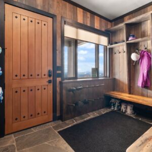 Wood door in boot room designed by Big White, BC custom home builder & Kelowna custom home builder designer