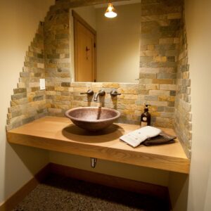 Tiled backsplash in powder room Unique display wine rack in custom wine room design built by Kelowna high-end builder & Kelowna Contractor