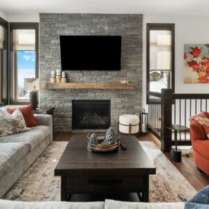Rustic wood mantle rock fireplace designed by Big White & Kelowna custom home builder designer