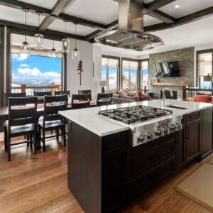 Stainless steel appliances in compact kitchen designed by Big White custom home builder & Kelowna custom home builder designer
