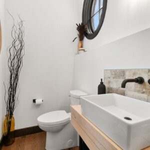 Clean modern powder room Custom tiled shower with bench built by Big White BC & Kelowna custom home builder designer