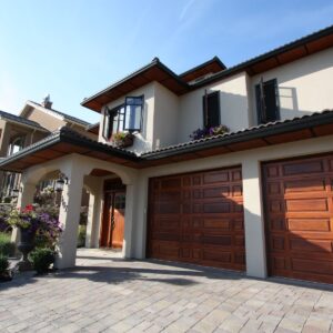 Solid wood garage doors in Mediterranean home in Kelowna, BC designed by Kelowna custom builder & Kelowna construction company