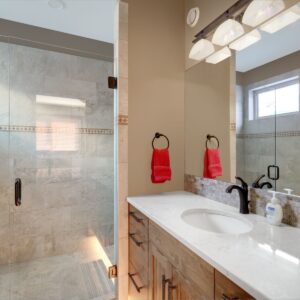 Glass shower doors on tiled shower designed by Big White custom chalet builder & Kelowna custom home builder