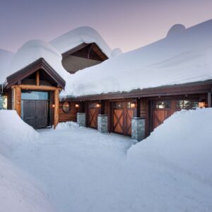 Log accents and wood garage doors on ski chalet designed & built by Big white custom home builder 7 Kelowna custom home builder Weninger Construction & Design