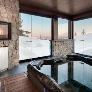Luxury glass wall featured in custom designed hot tub room in ski chalet built by Big White builder & Kelowna Contractor Weninger Construction & Design