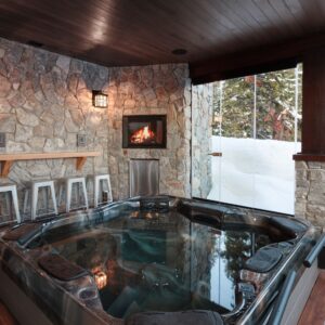 Rock wall in custom hot tub room in ski chalet built by Big White builder & Kelowna Contractor Weninger Construction & Design