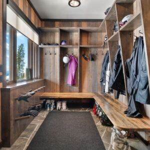 Custom bootroom with wormwood epoxy bench and barnboard wall cladding.